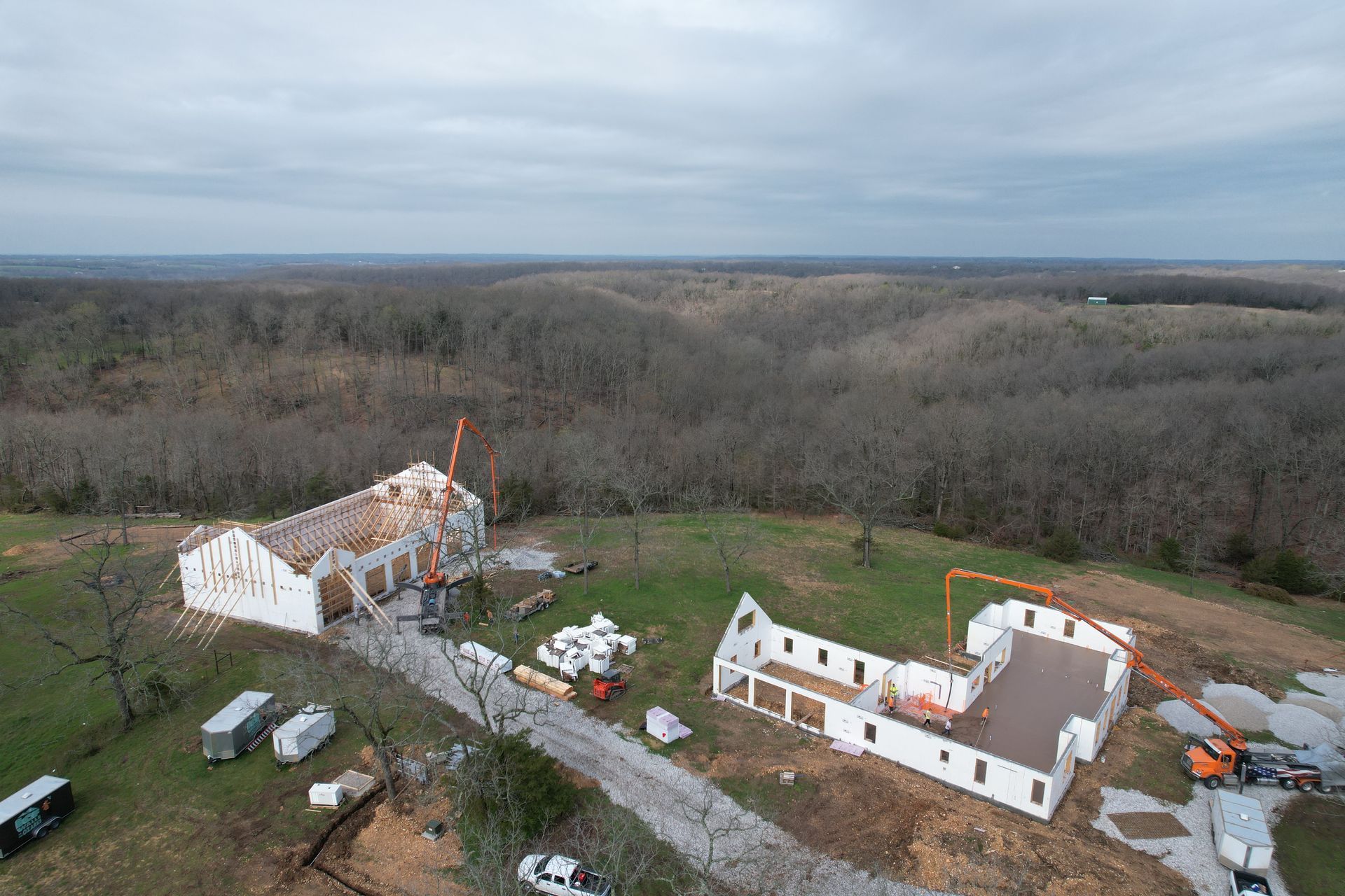 An aerial view of an ICF house and shop under construction in the middle of a field- Rogers AR Builders
