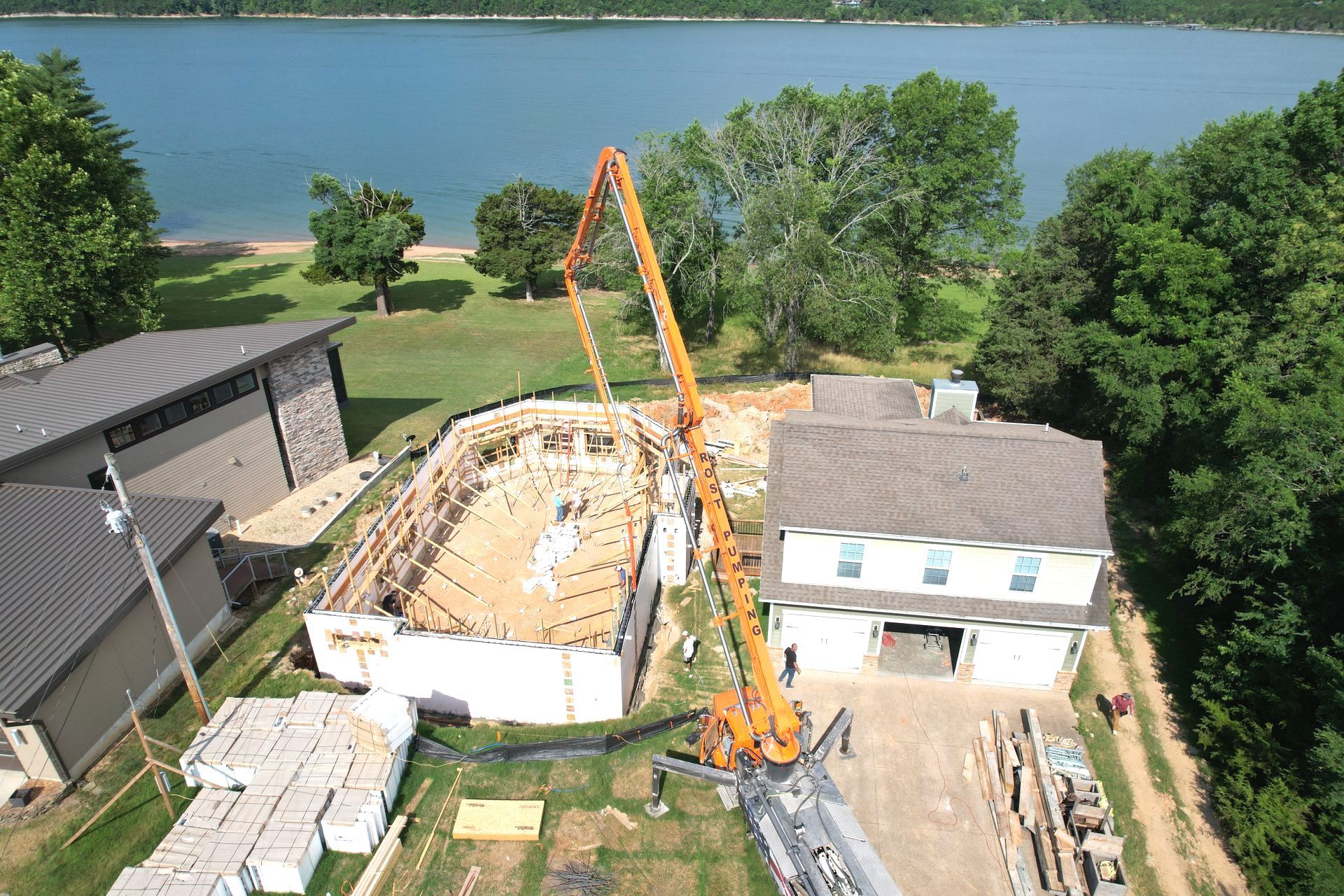 Truck pumping concrete into insulated concrete form home by lake | Branson, MO