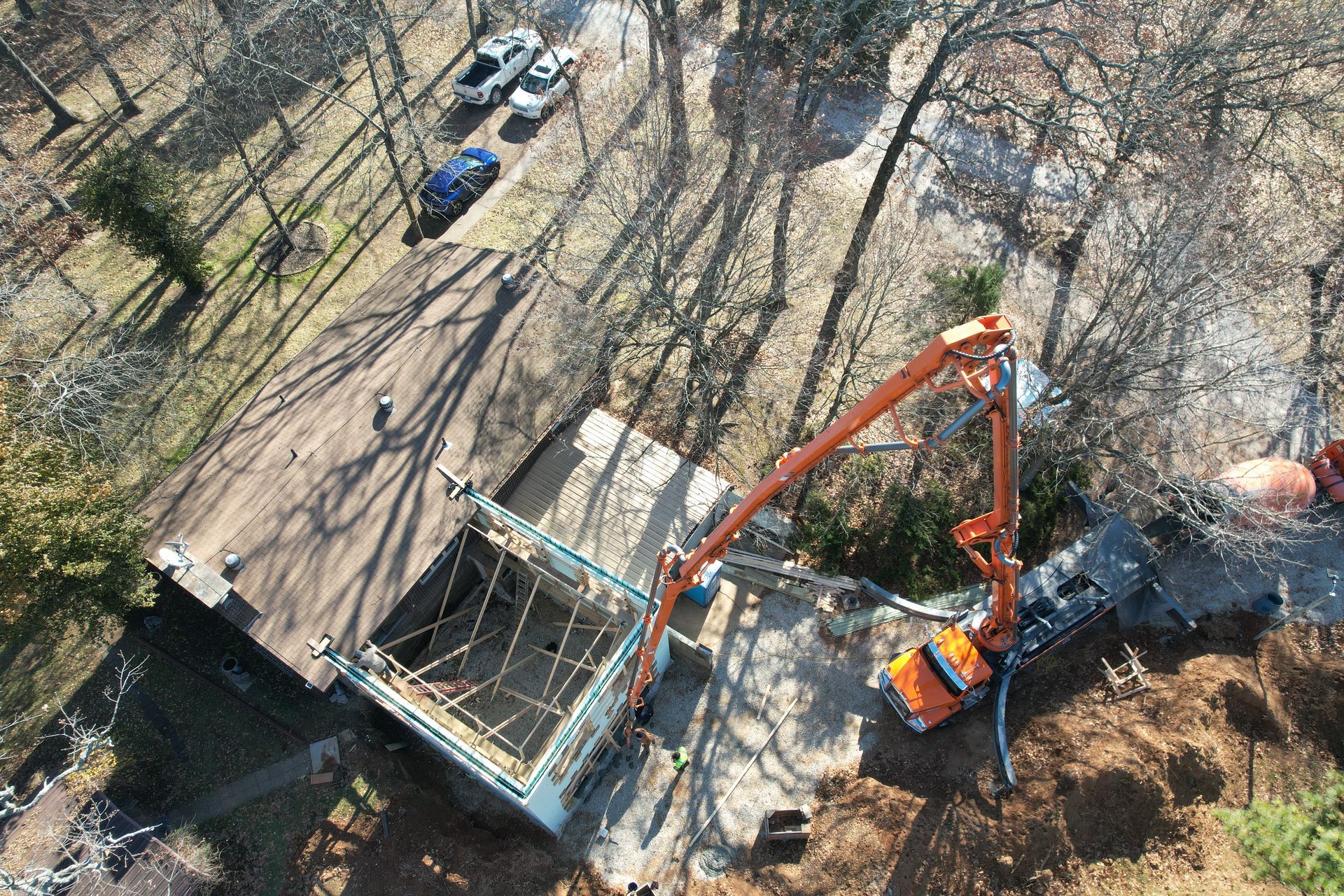 An aerial view of an ICF house addition being built with a concrete pump.