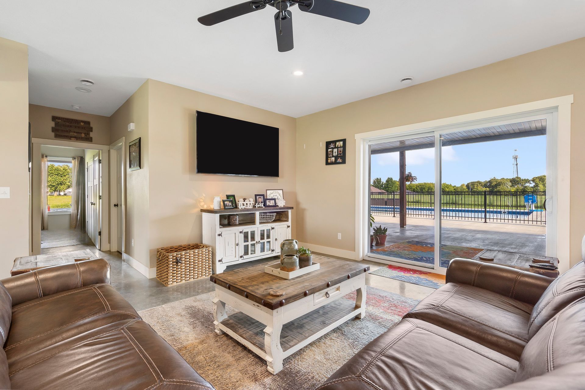 Insulated concrete form custom home family room with view of in-ground pool in backyard | Ozark, MO