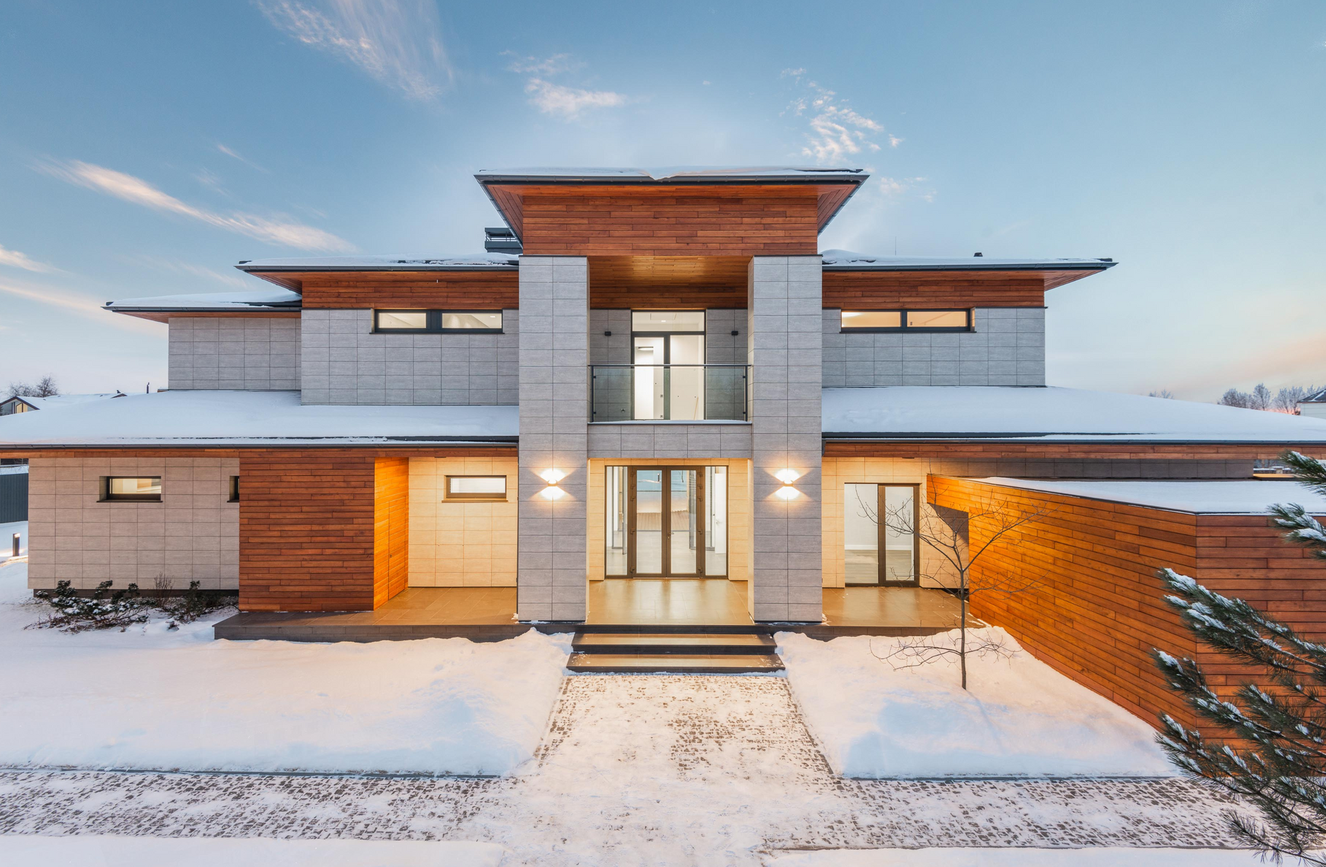 A contemporary ICF house with a lot of windows is covered in snow | Ozark MO