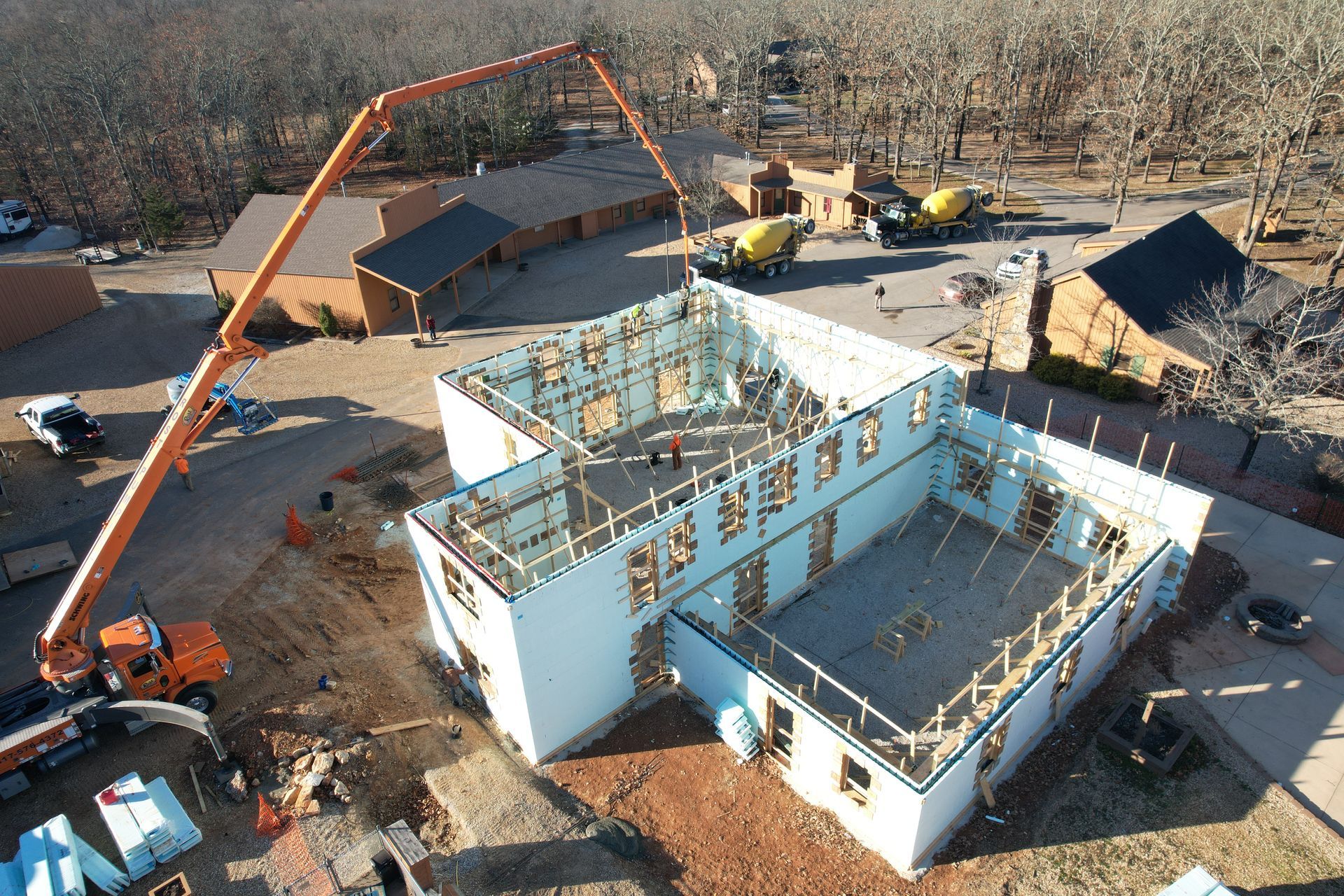Insulated concrete forms reinforced with rebar and being filled with concrete in winter | Rogersville, MO