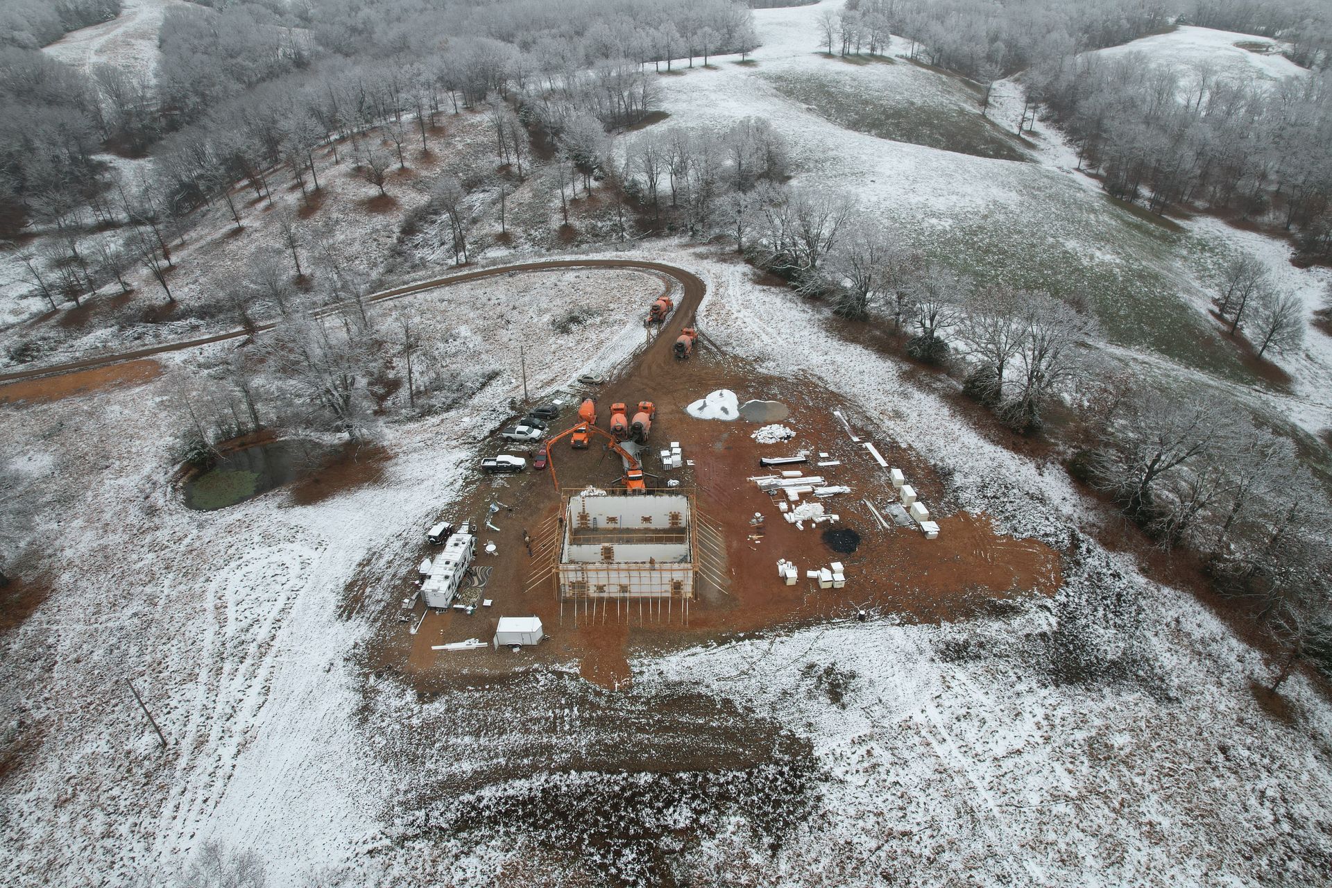 Custom ICF home with walls being filled with concrete in snowy landscape in the Ozarks | Springfield, MO