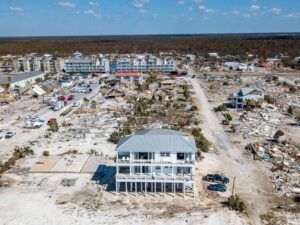 An aerial view of an ICF house still standing in the middle of destruction left by a hurricane- Jefferson City MO Builders