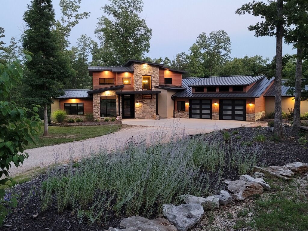 Custom concrete home with exterior lighting and landscaping | Ozark, MO