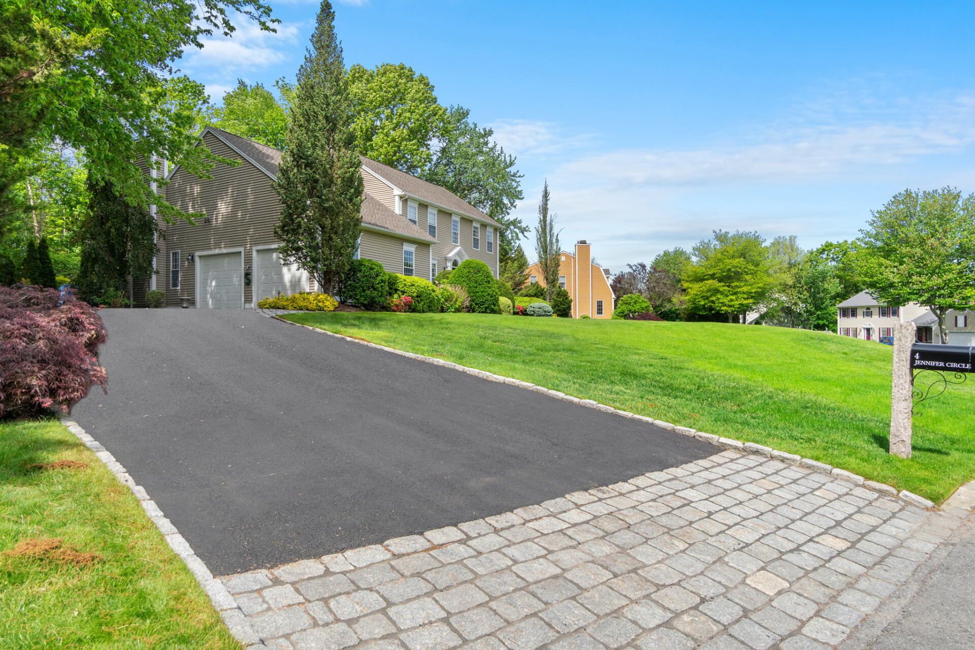 a home with a new paved drivewat