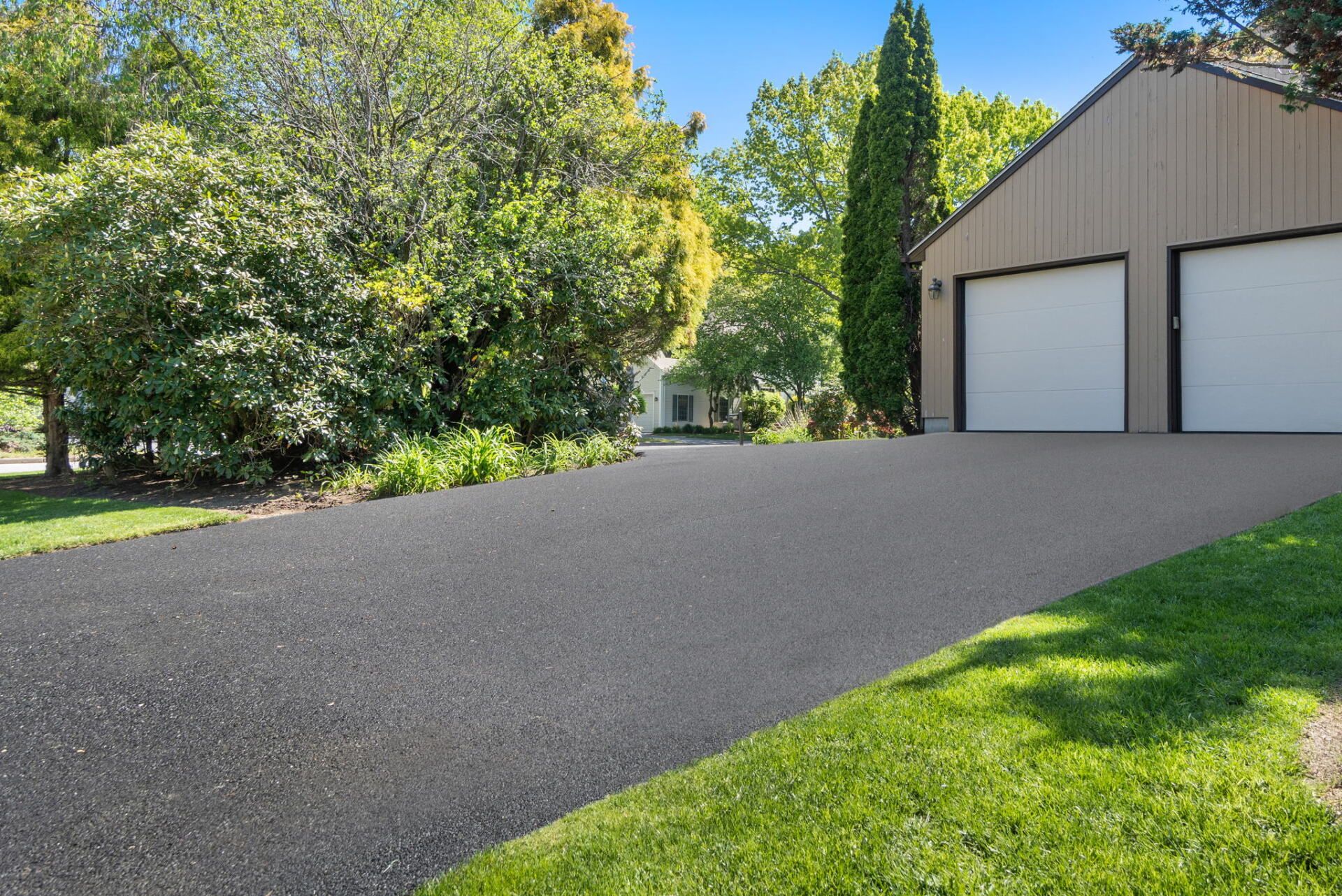 a garage with a new paved driveway