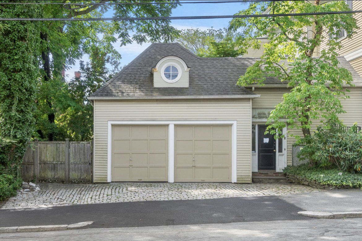 A garage with a roof that has a round window on top of it.