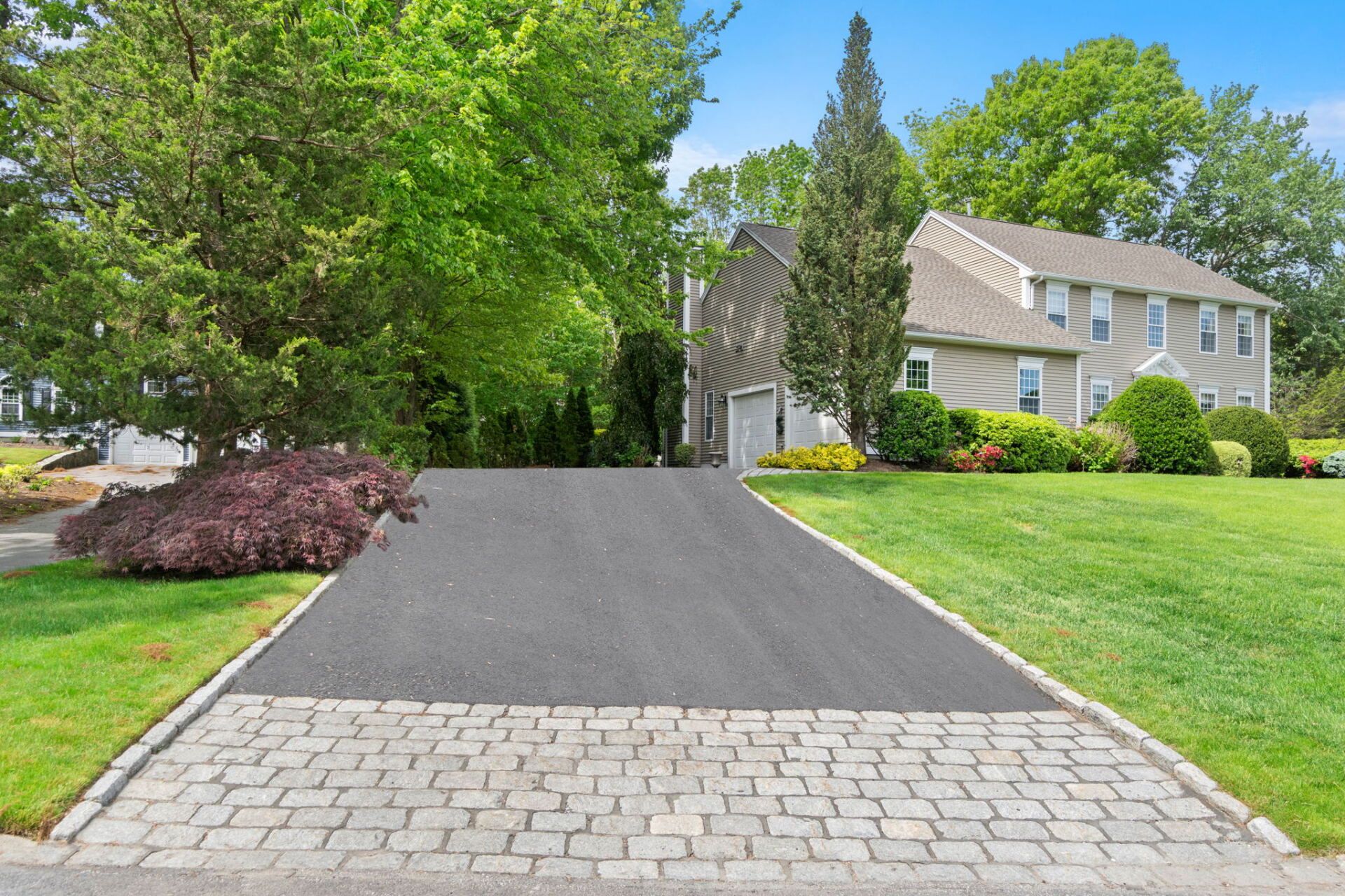 a house with a new paved driveway