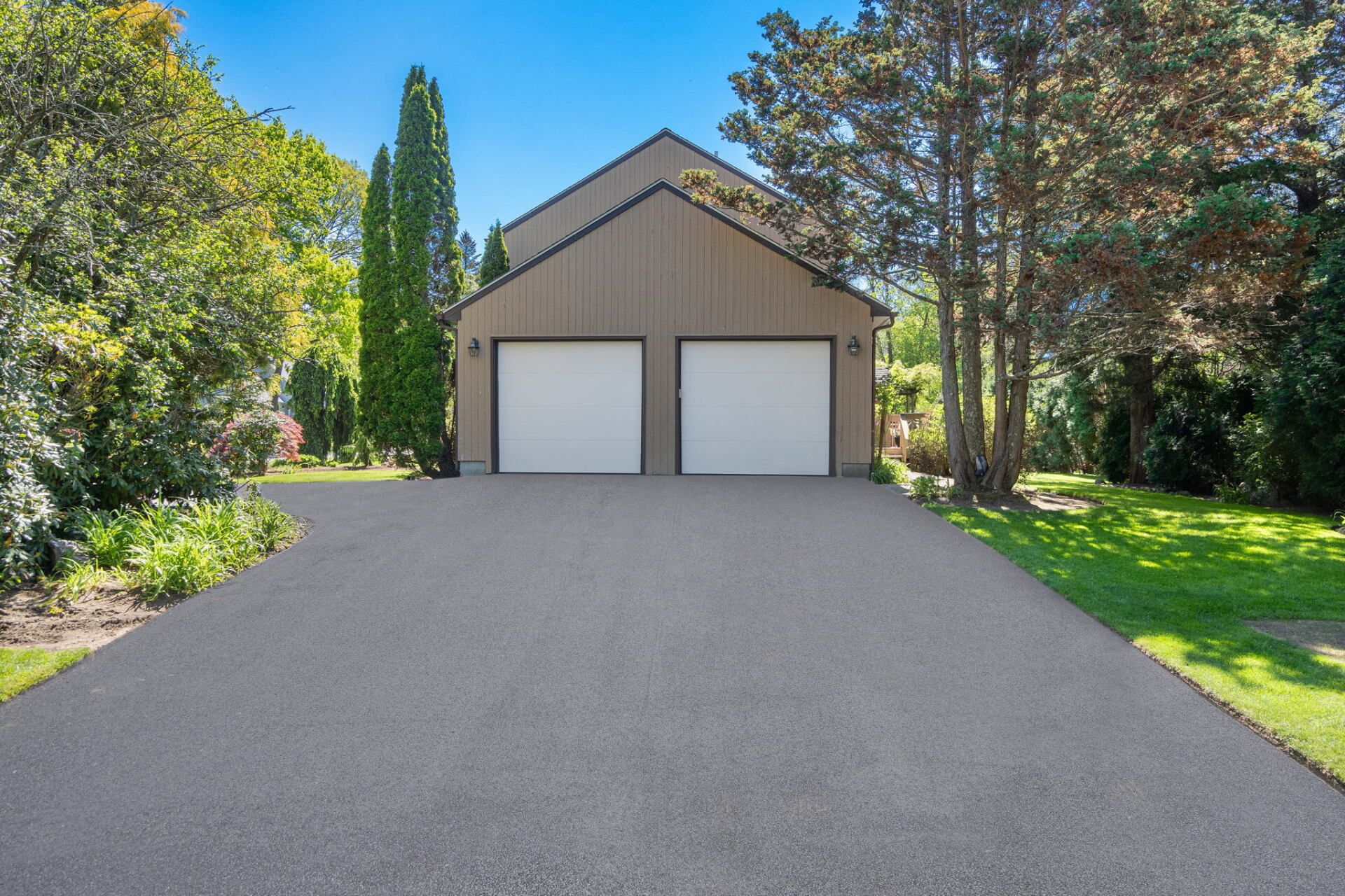 a garage with a new paved driveway