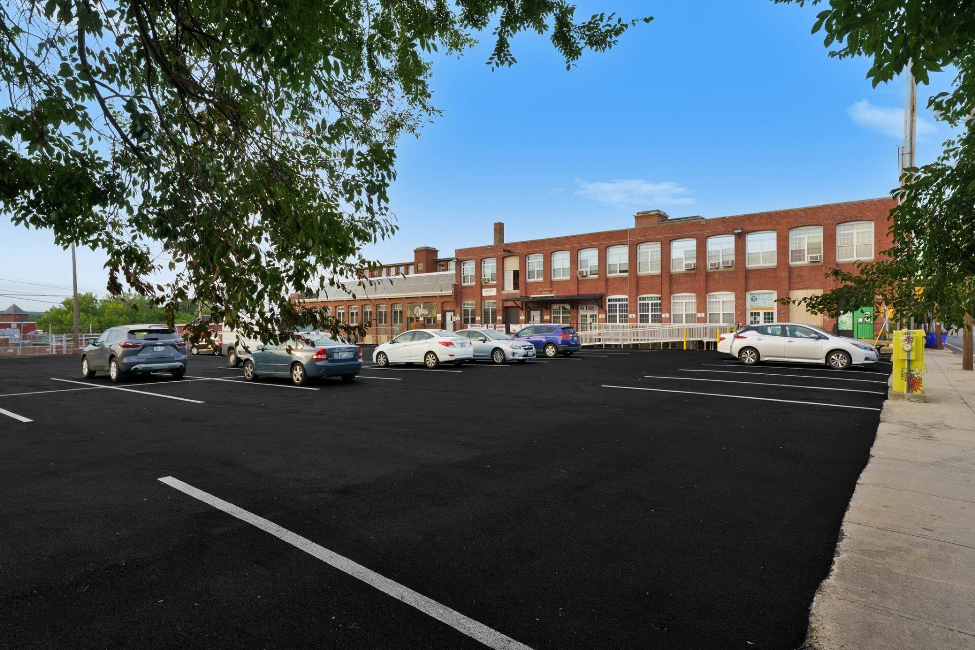 A parking lot with cars parked in front of a building