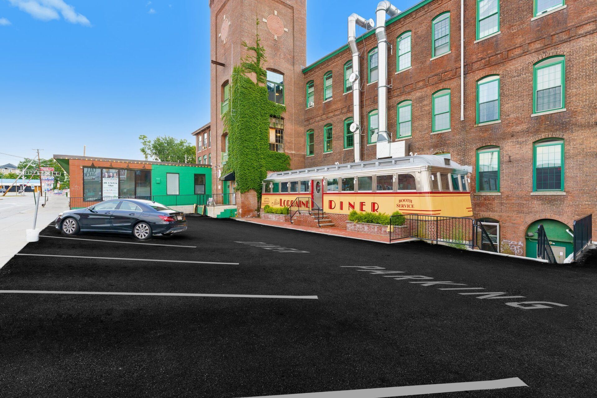 A parking lot with a diner in the background