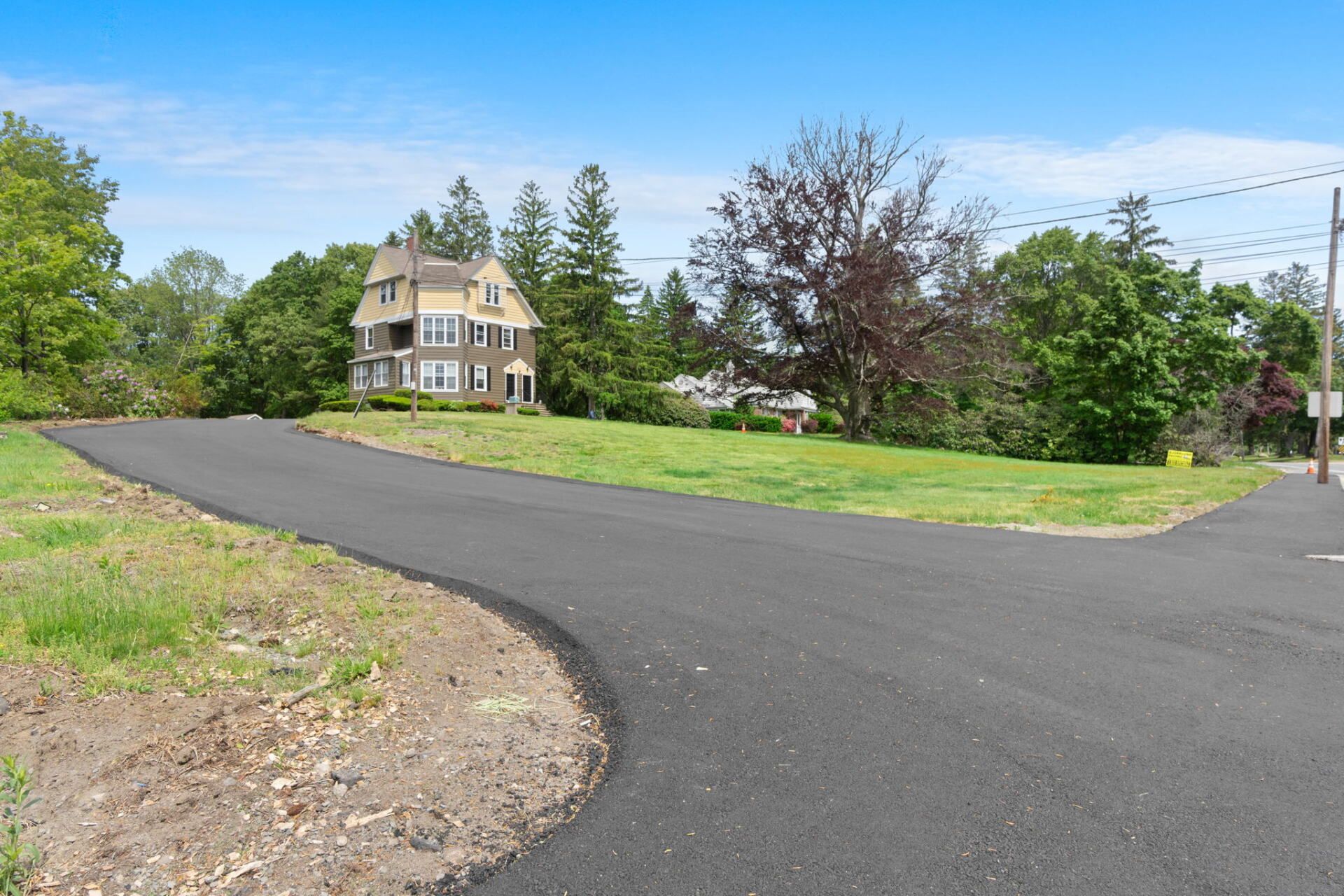 a home with a new paved drivewat