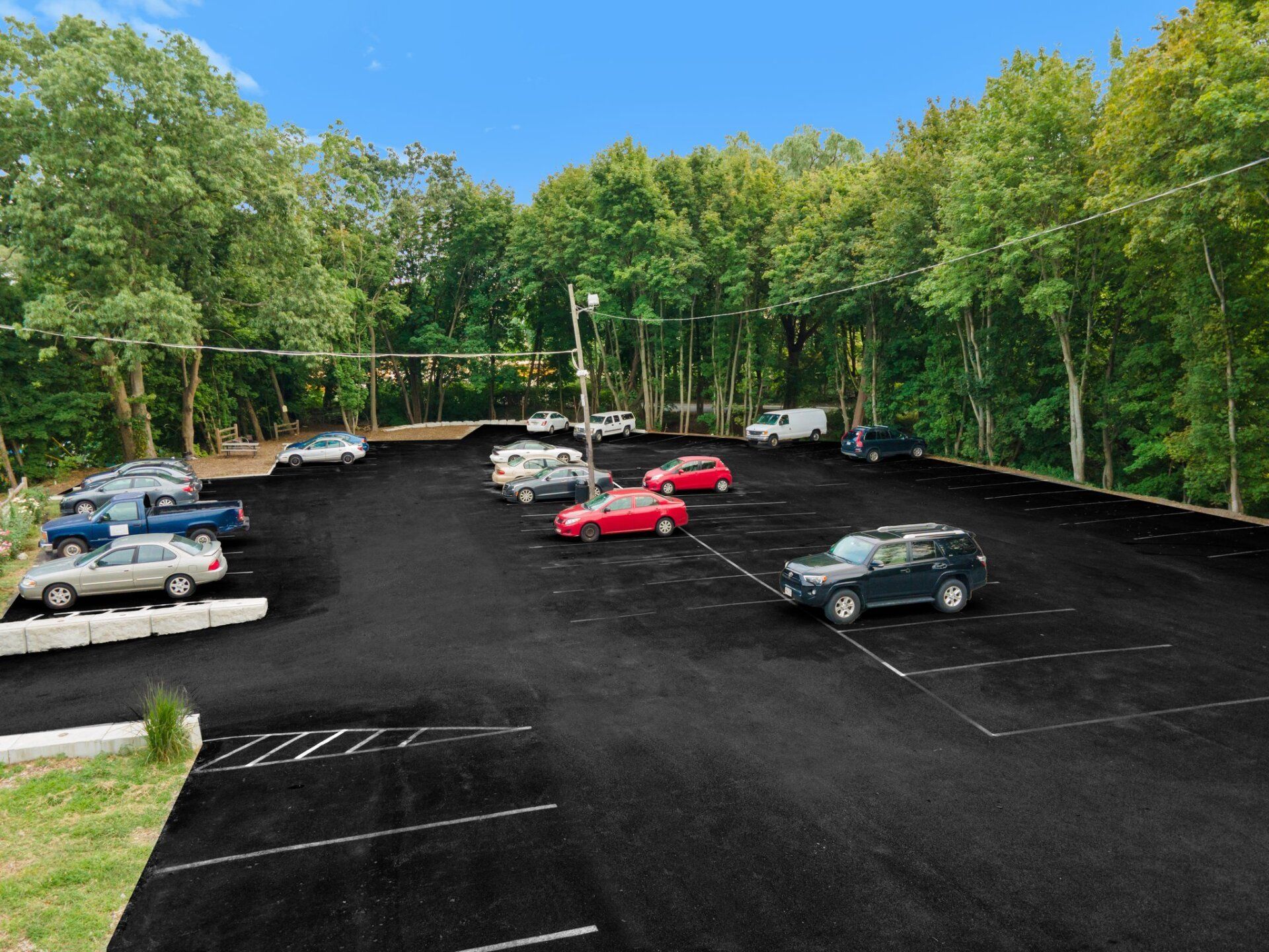 a parking lot with a new paved driveway