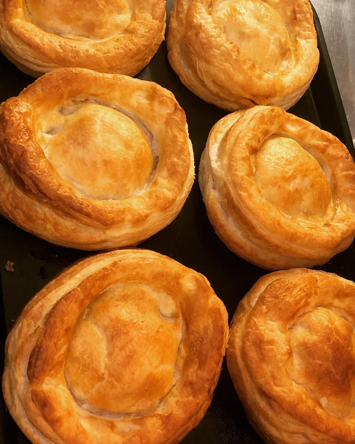 Un mucchio di pasticcini sono appoggiati su un vassoio nero