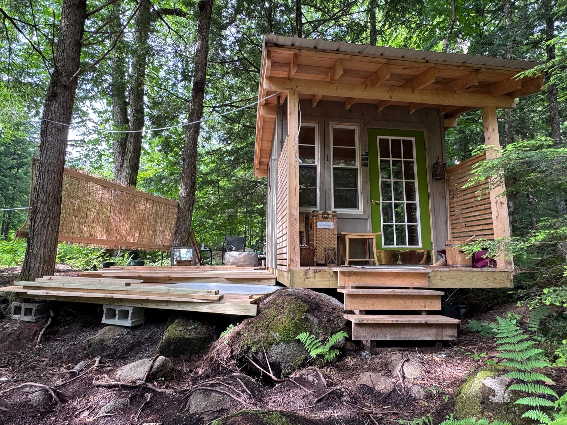 Heather standing on te porch of the tree house