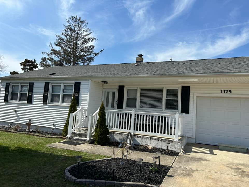 ranch-style house with new white vinyl siding and black shutters installed by quality affordable construction llc in pleasantville, nj