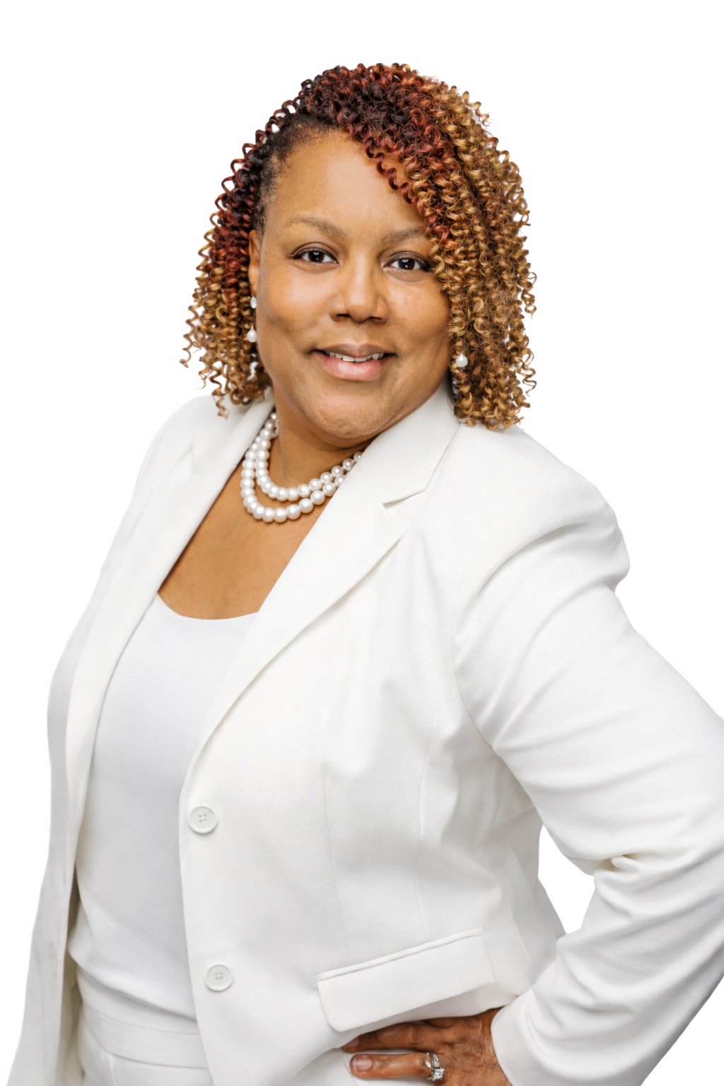 A woman is smiling, wearing a pearl necklace with matching earrings, white camisole, and white blazer .