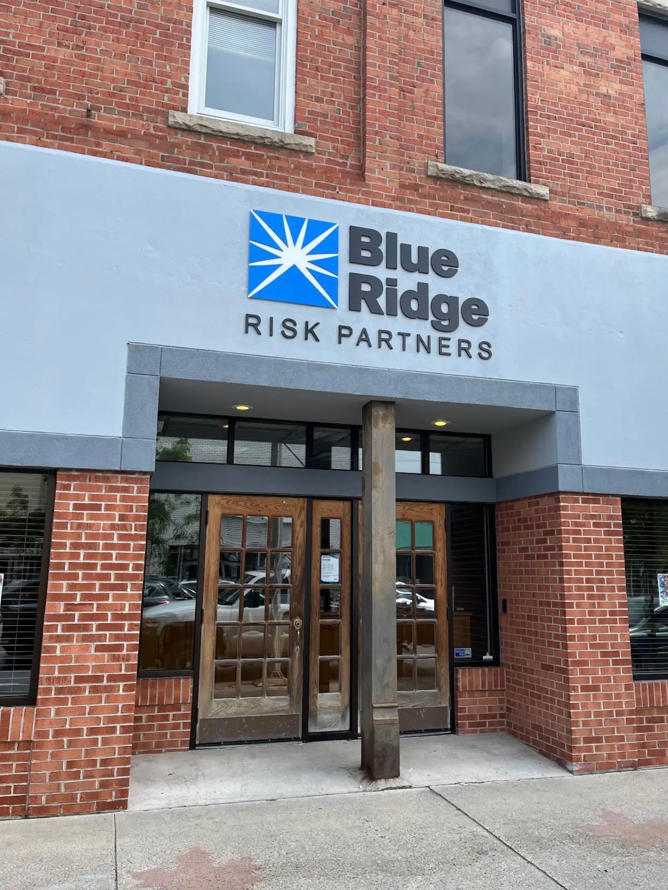 A man is painting a wall with a paint roller.