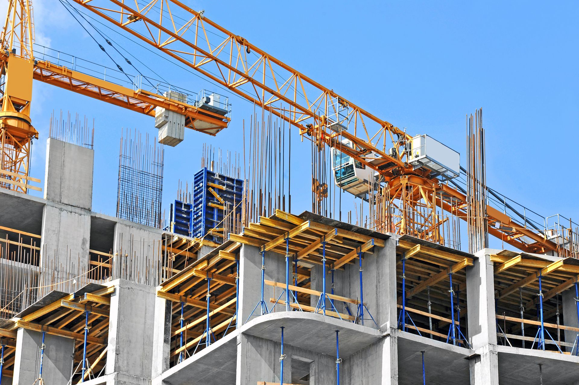 A large building is being built with cranes and scaffolding.