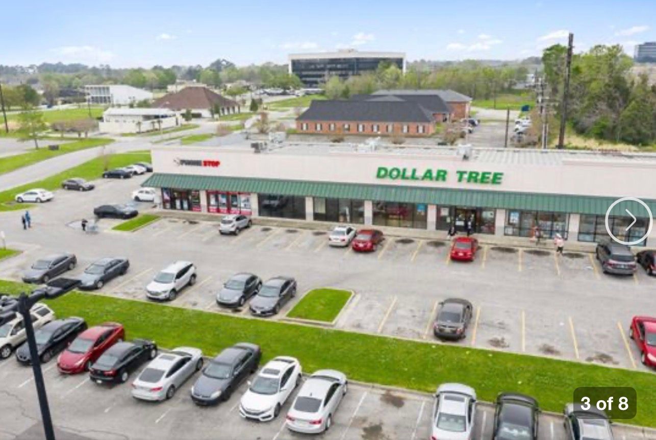 Plaza Village Lafayette LA storefronts and Beau Monde Services sign; commercial property maintenance example.