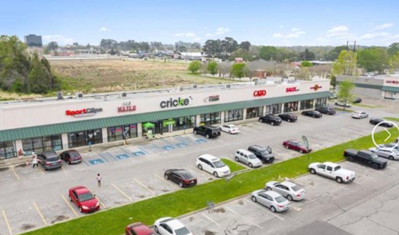 Plaza Village Lafayette LA storefronts and Beau Monde Services sign; commercial property maintenance example.