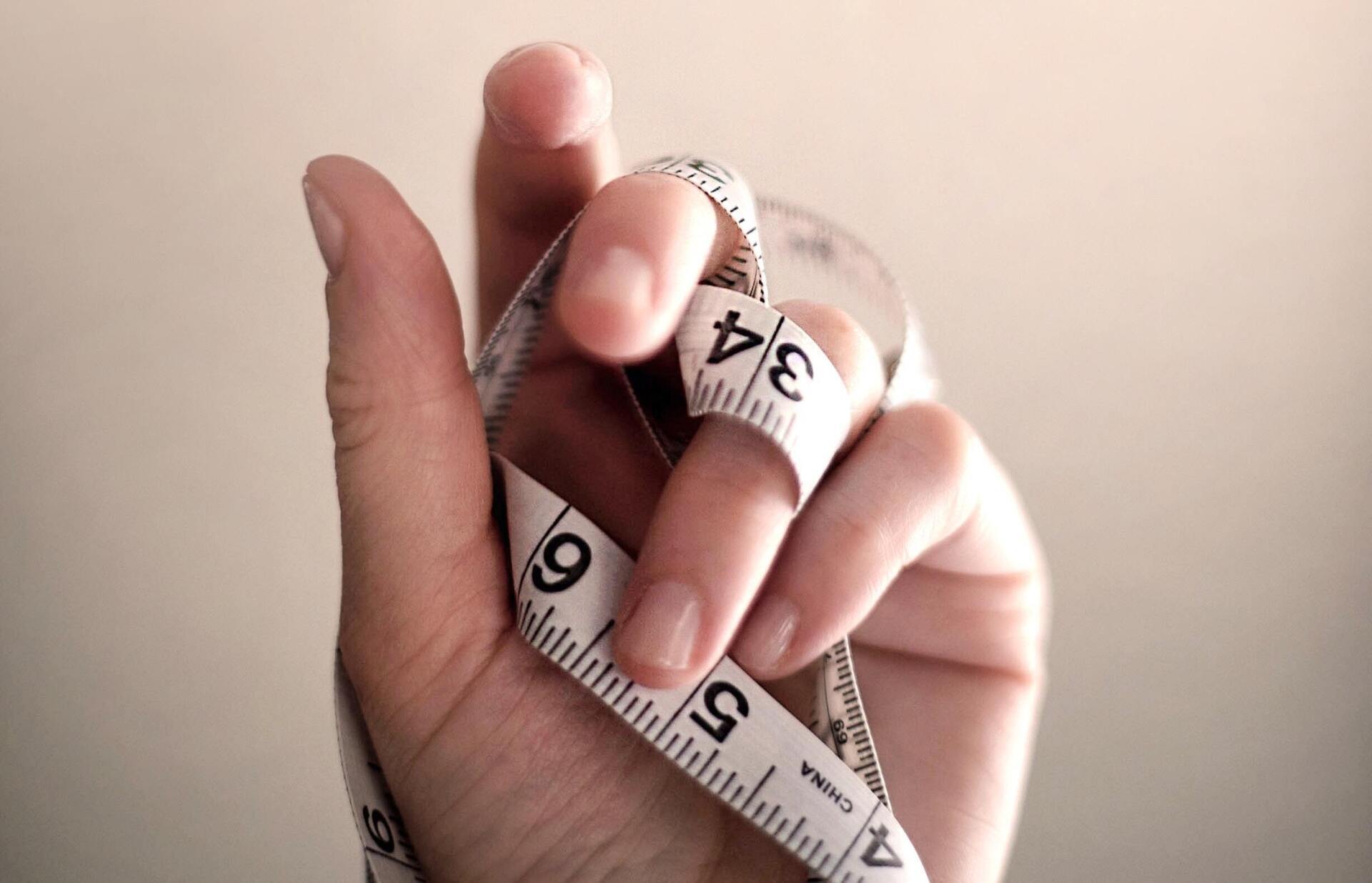 hand with tape measure
