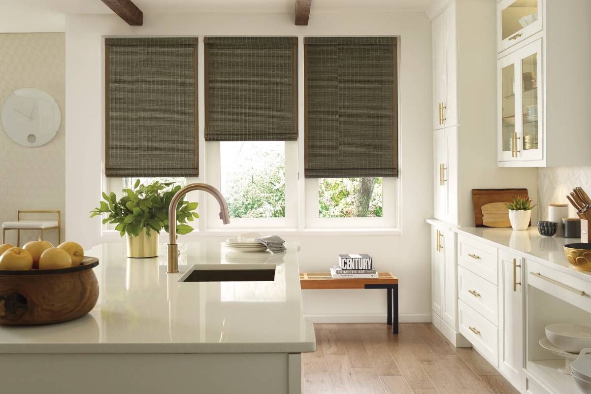 Luxe home kitchen with three windows all covered with Hunter Douglas Provenance® Woven Wood Shades at Rachel Brosky Interiors near Elizabethtown, Kentucky (KY)