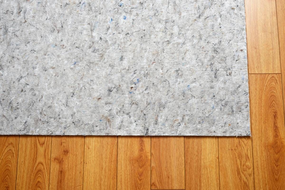 A felt area rug pad on top of hardwood floors to provide added comfort at Rachel Brosky Interiors near Elizabethtown, Kentucky (KY)