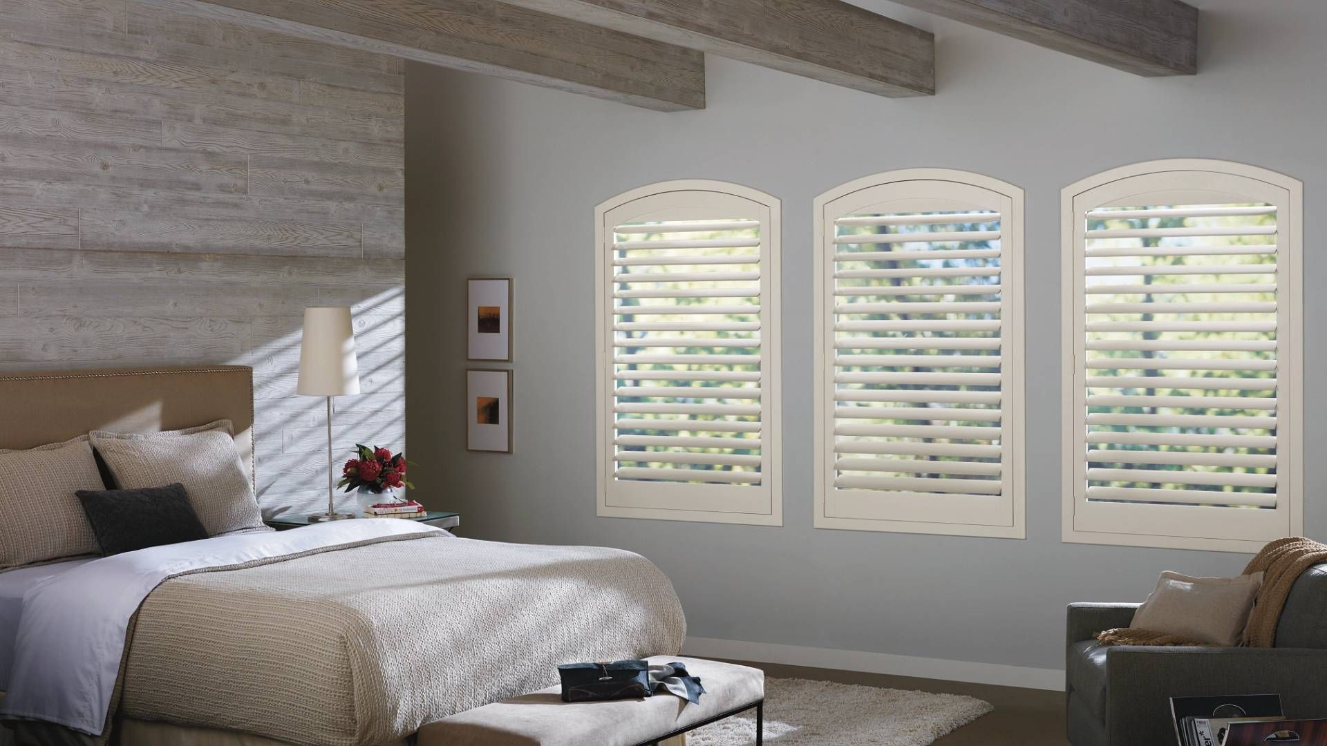 Hunter Douglas NewStyle® Composite Shutters primary bedroom windows with a traditional theme with ru