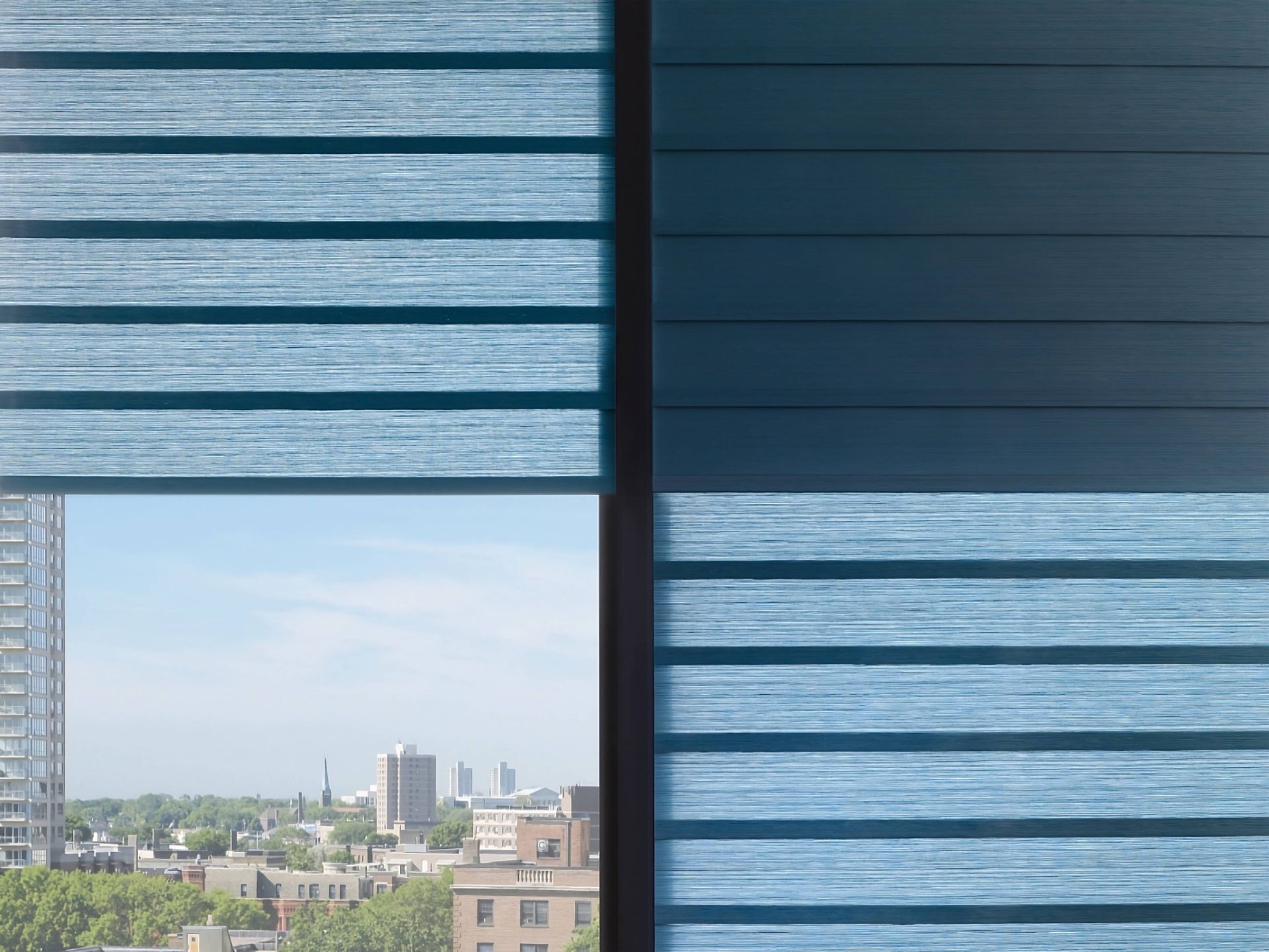 Up-close product image of blue Roman shade fabrics with a room-darkening liner on a window at Rachel Brosky Interiors near Elizabethtown, Kentucky (KY)