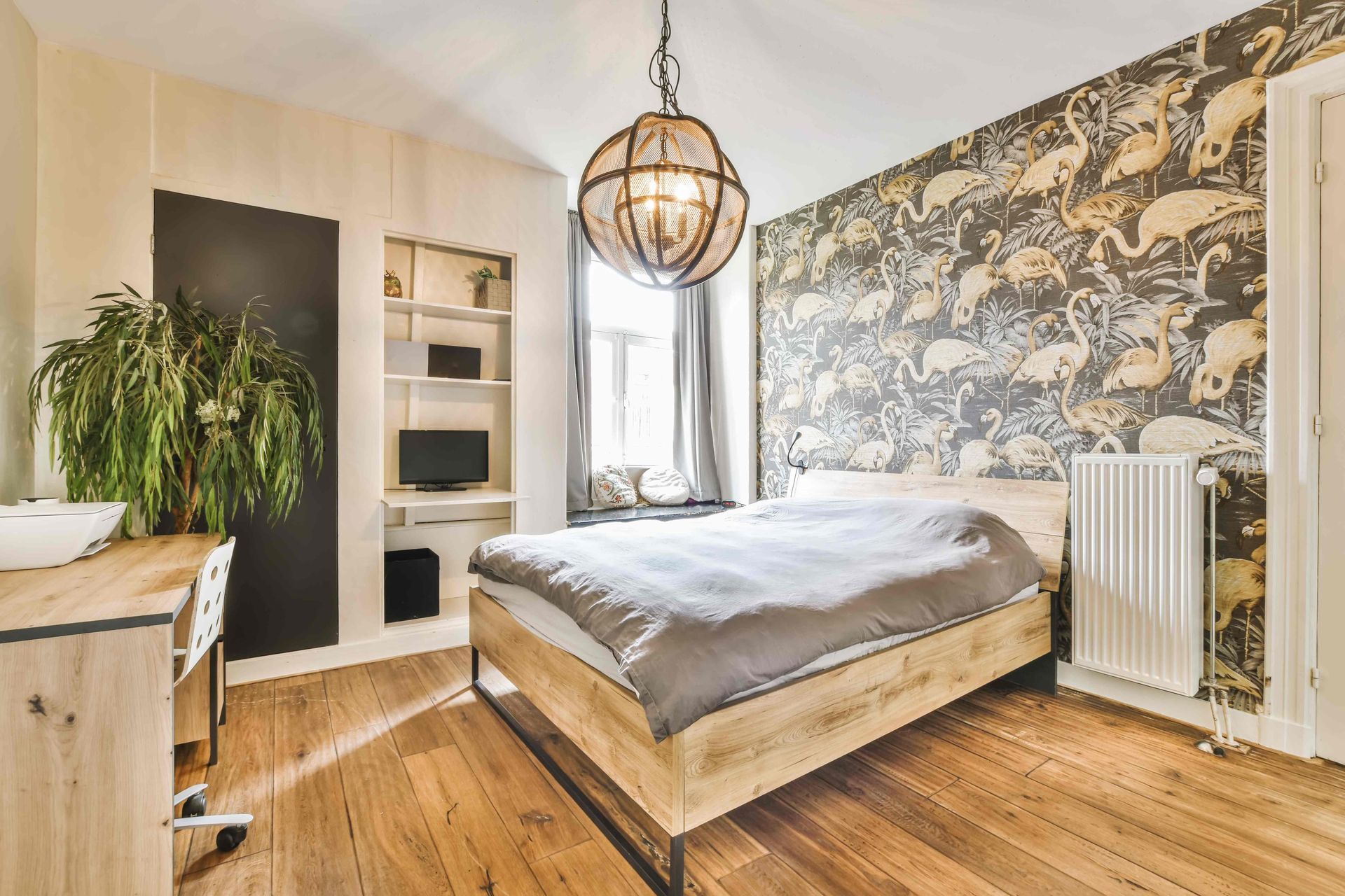 Accent wallpaper of a bird in a bedroom complementing the bedspread and window curtains