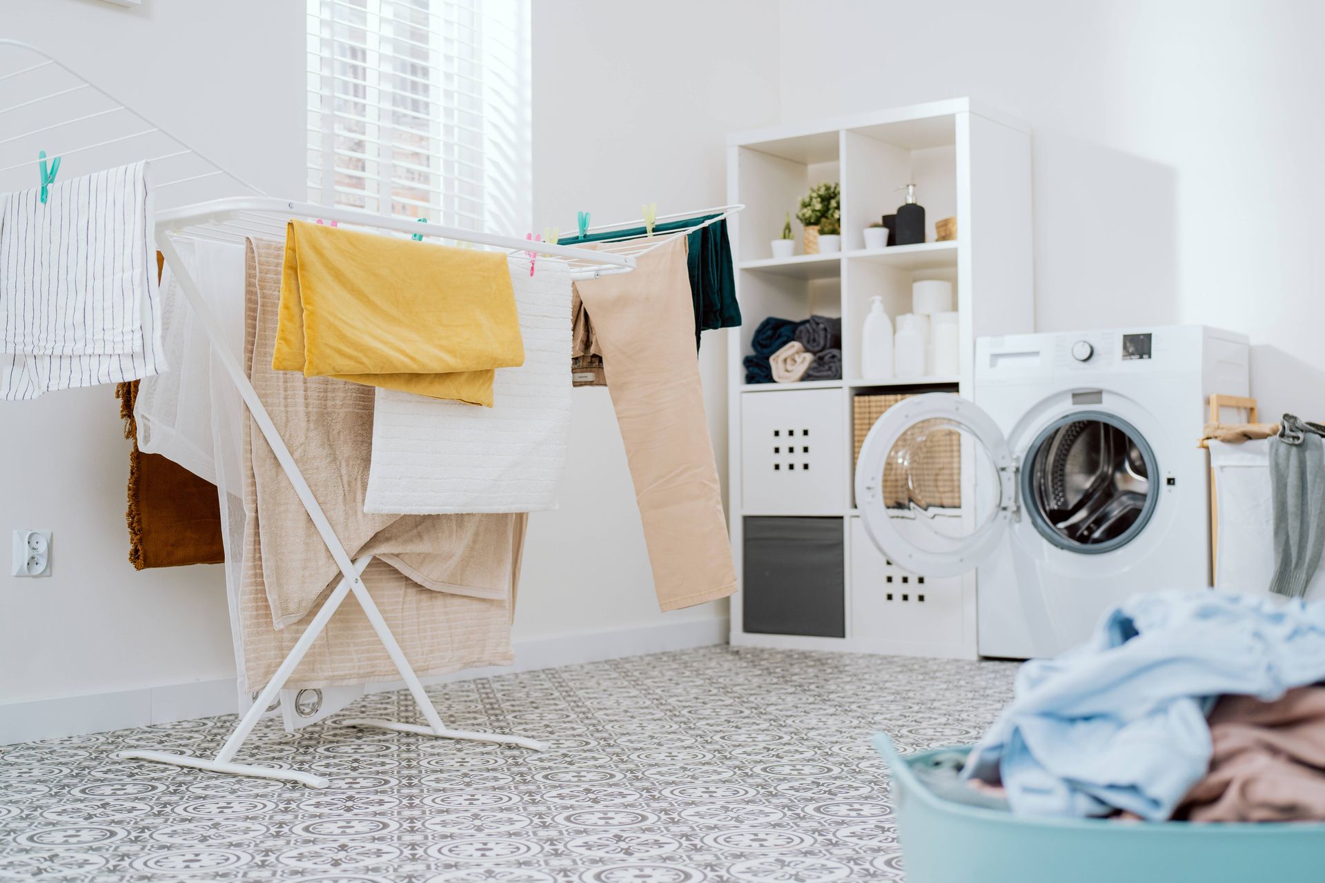  A busy laundry room with durable blinds on the window near the clothes line drying at Rachel Brosky Interiors near Elizabethtown, Kentucky (KY)