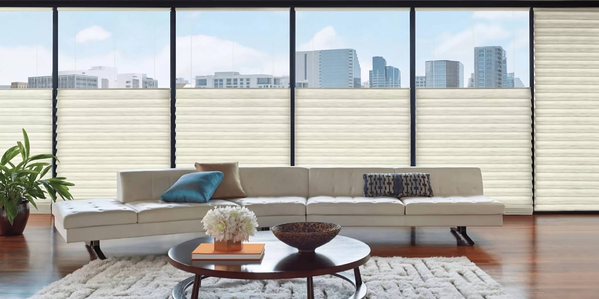 Hunter Douglas Top-Down/Bottom-Up Window Treatment in a modern living room overlooking a city skylin