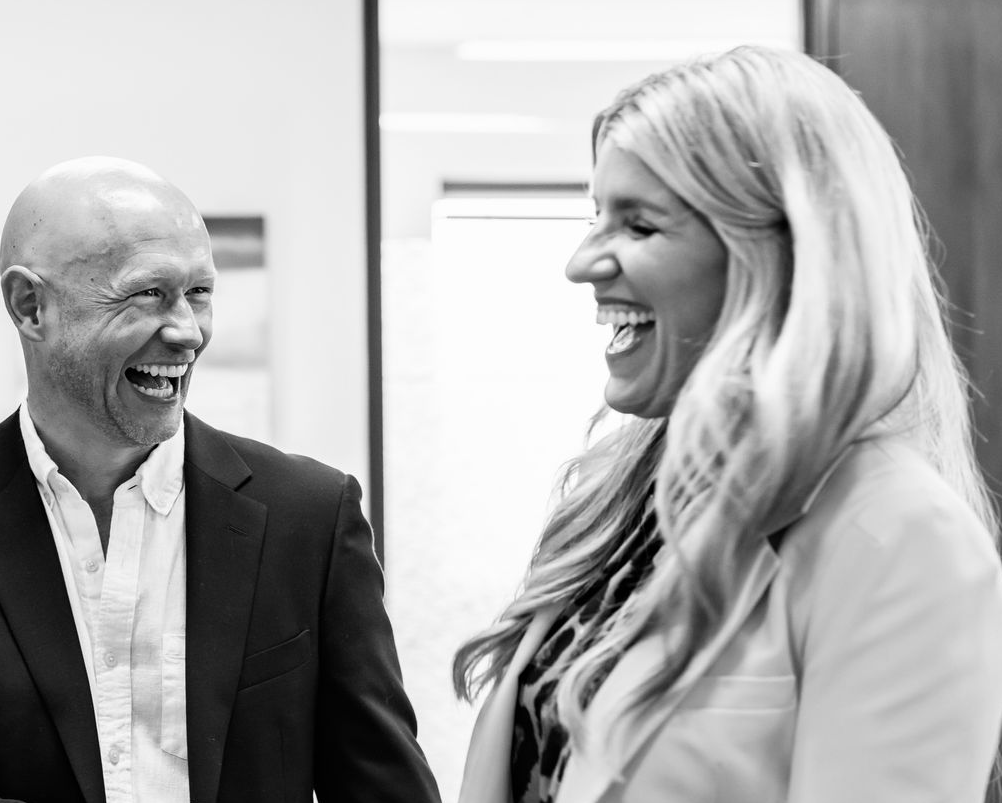 Allison Meier and friend in office setting smiling while in conversation