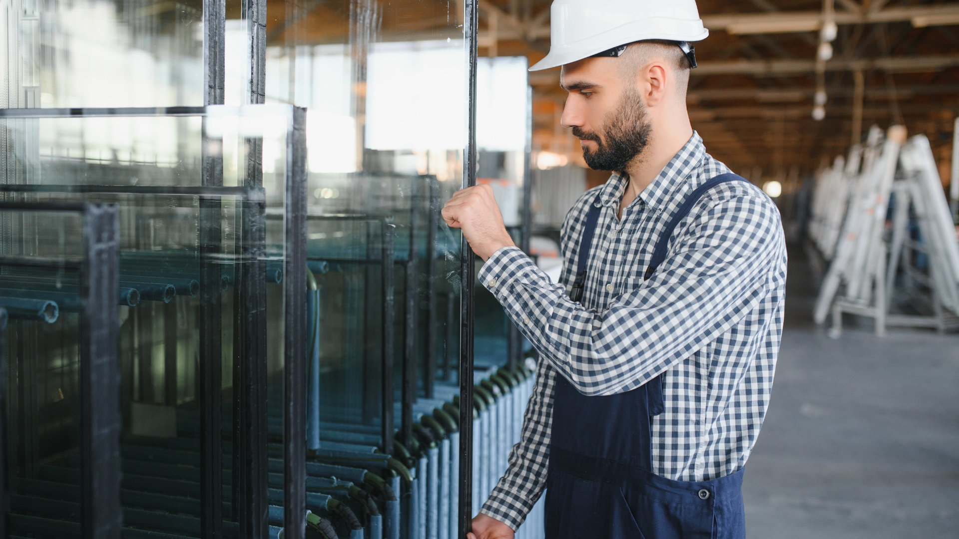 Corner shower with black framed glass panels, white subway tile walls, dark vanity and wooden floor.