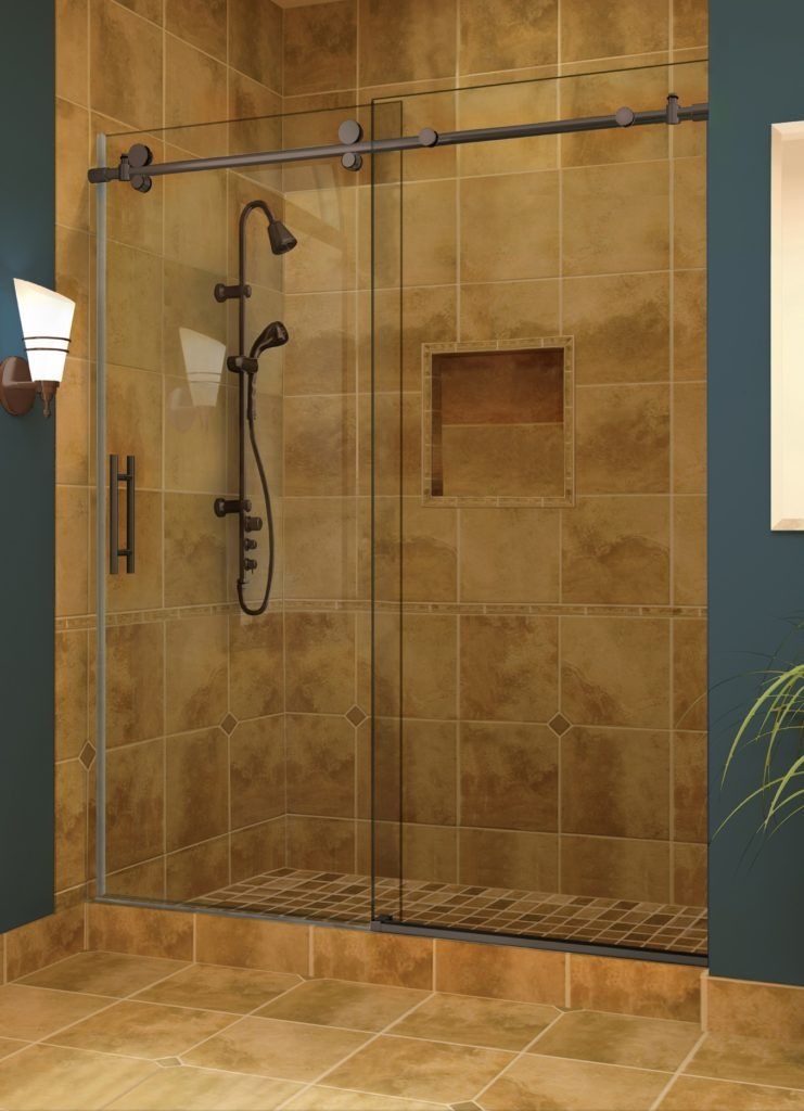 Shower stall with sliding glass door, bronze hardware, and brown tile walls and floor.