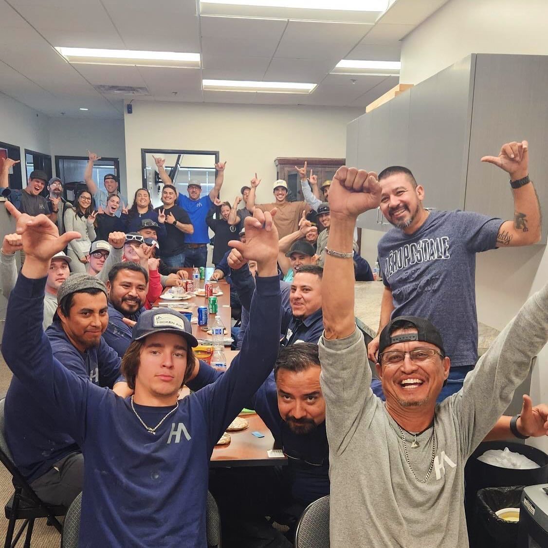 Two men are working on a roof with a crane