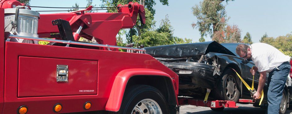 Towing — Red Tow Truck Towing Black Car in Midlothian, TX