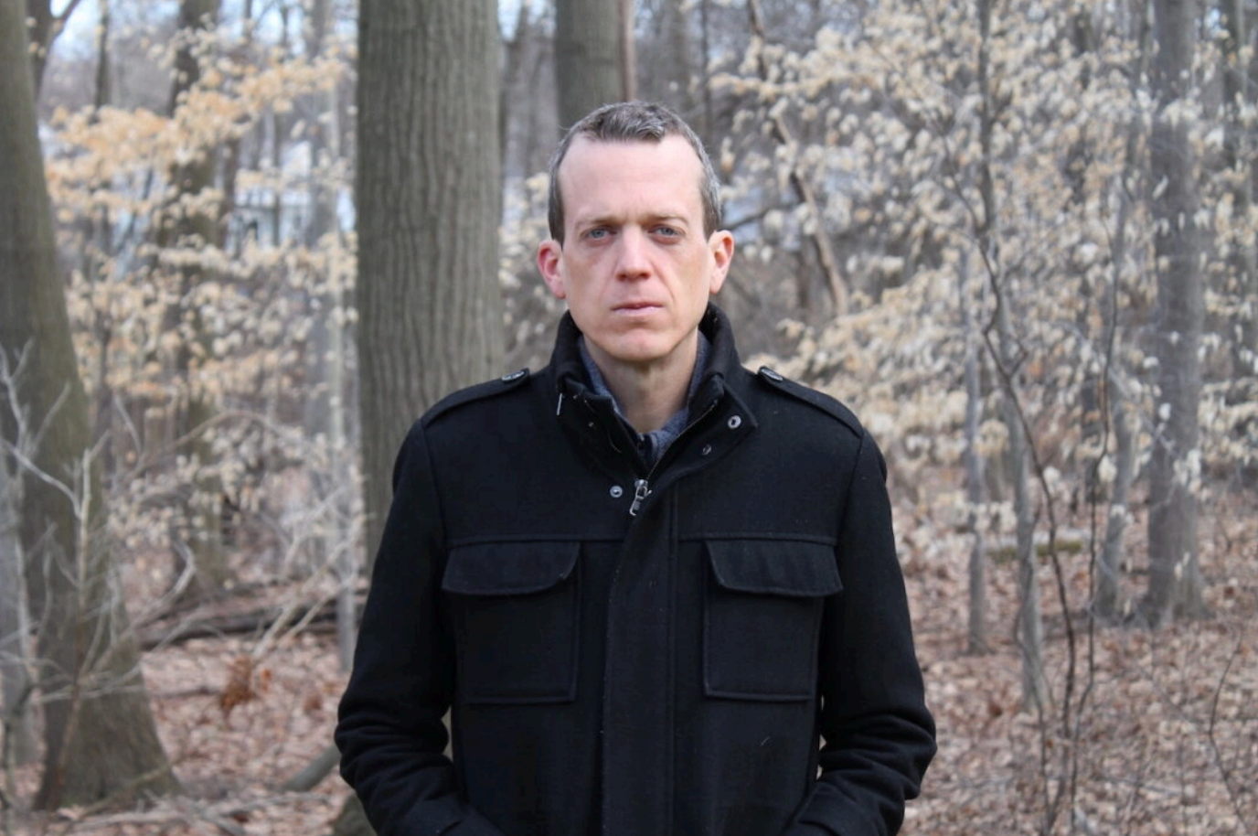 Ron Shaich is smiling in front of a panera bread store