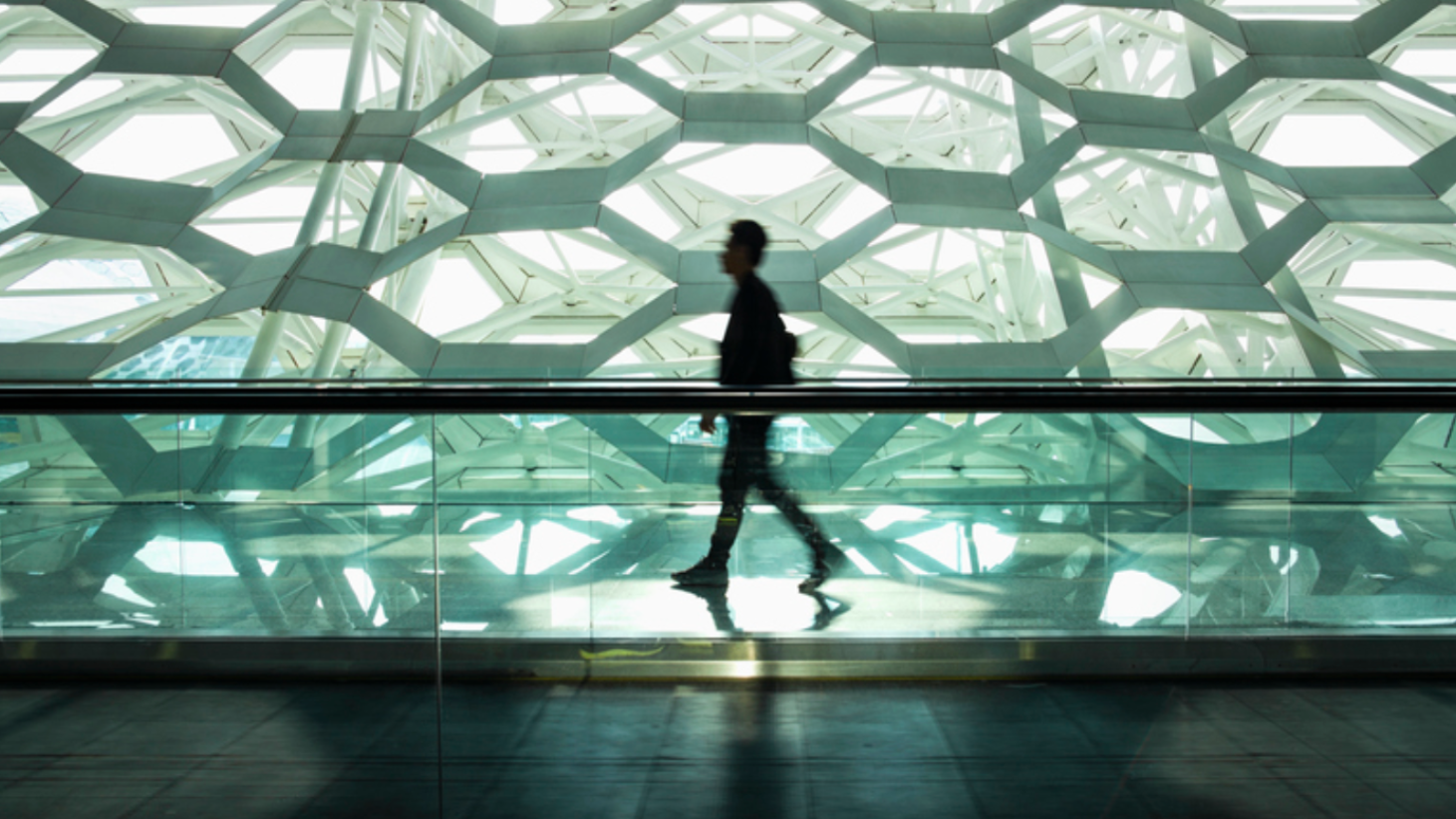 Ron Shaich is smiling in front of a panera bread store