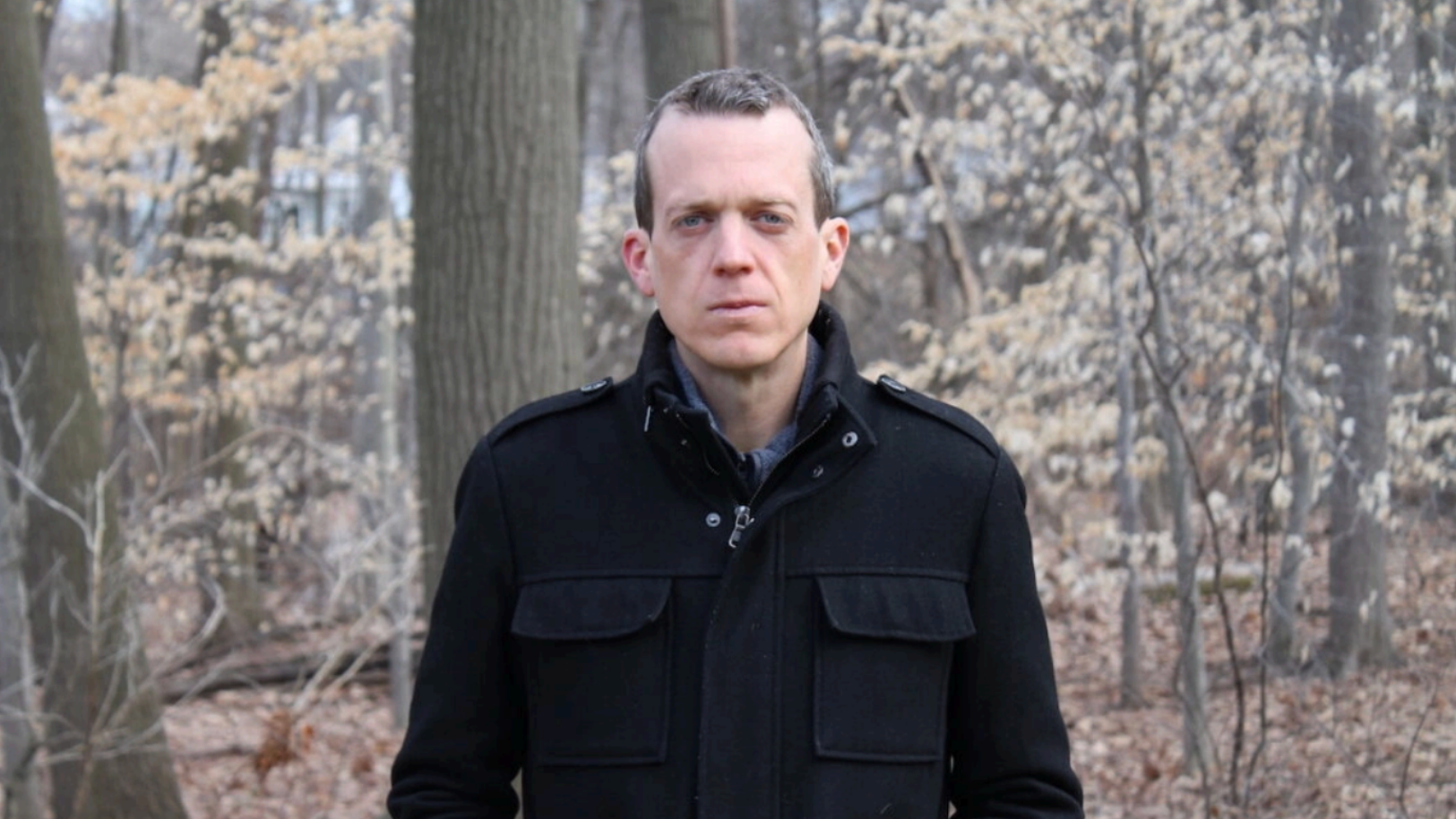 Ron Shaich is smiling in front of a panera bread store