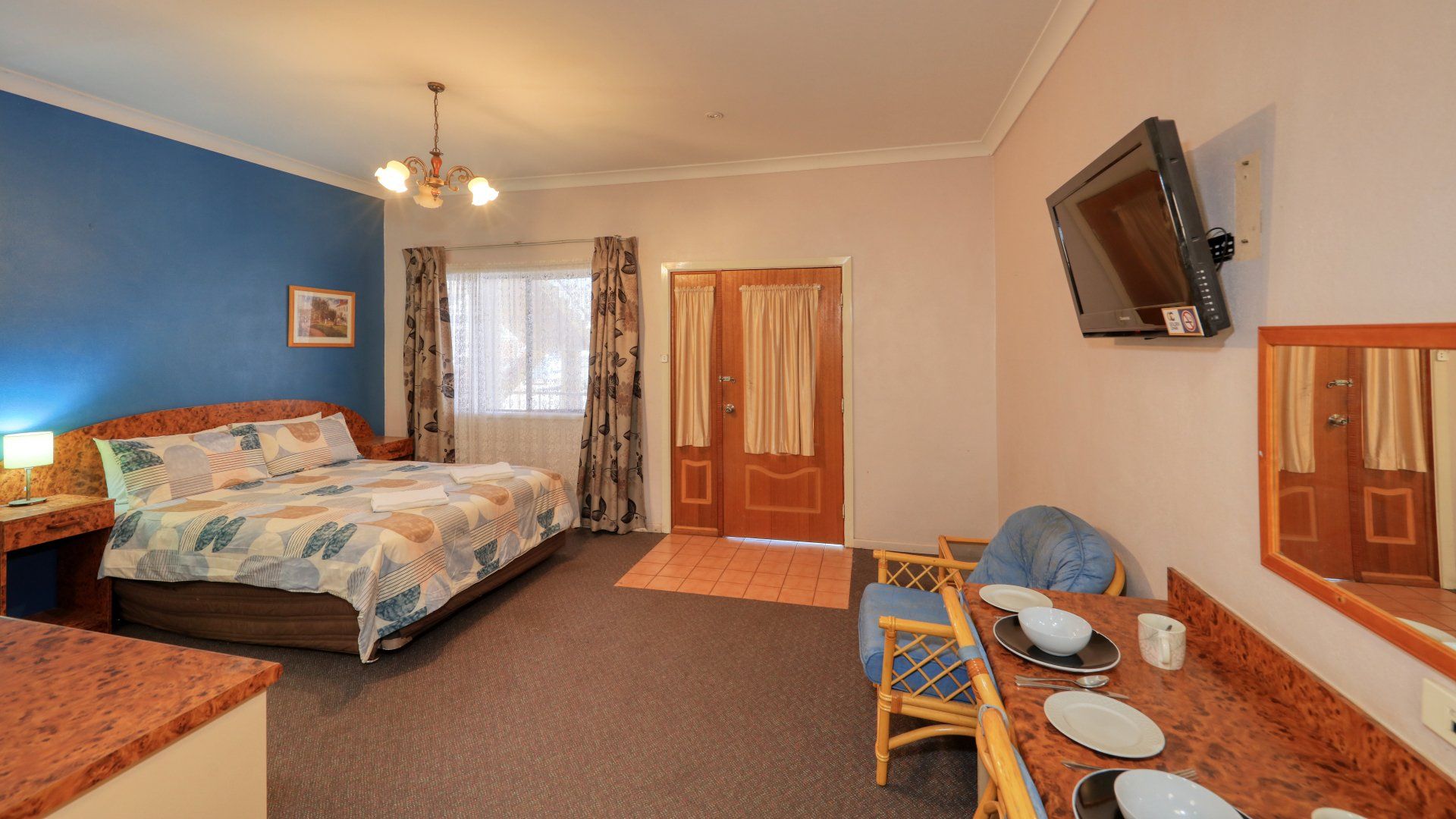 Spacious Bedroom With Chandelier And Curtain — Townview Motel In  Mount Isa QLD