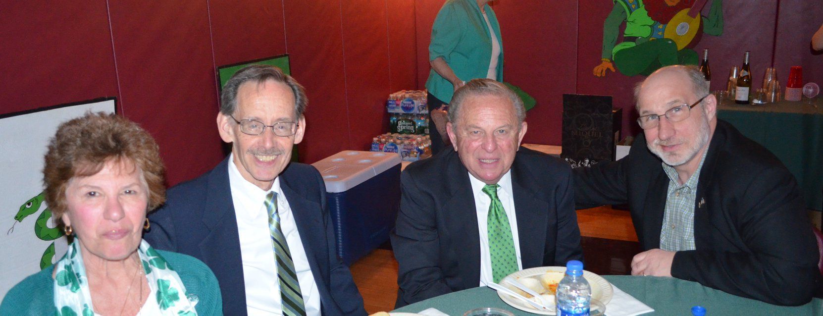 A group of people are sitting at a table and smiling