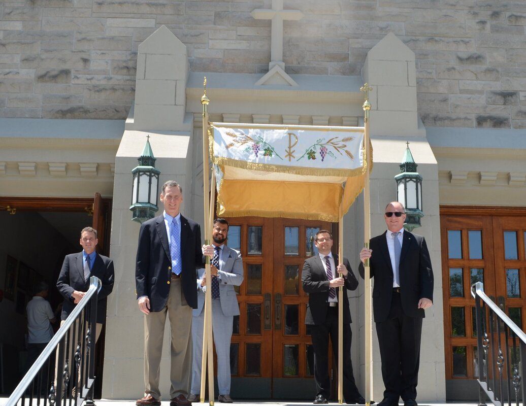 A group of men are standing in front of a church