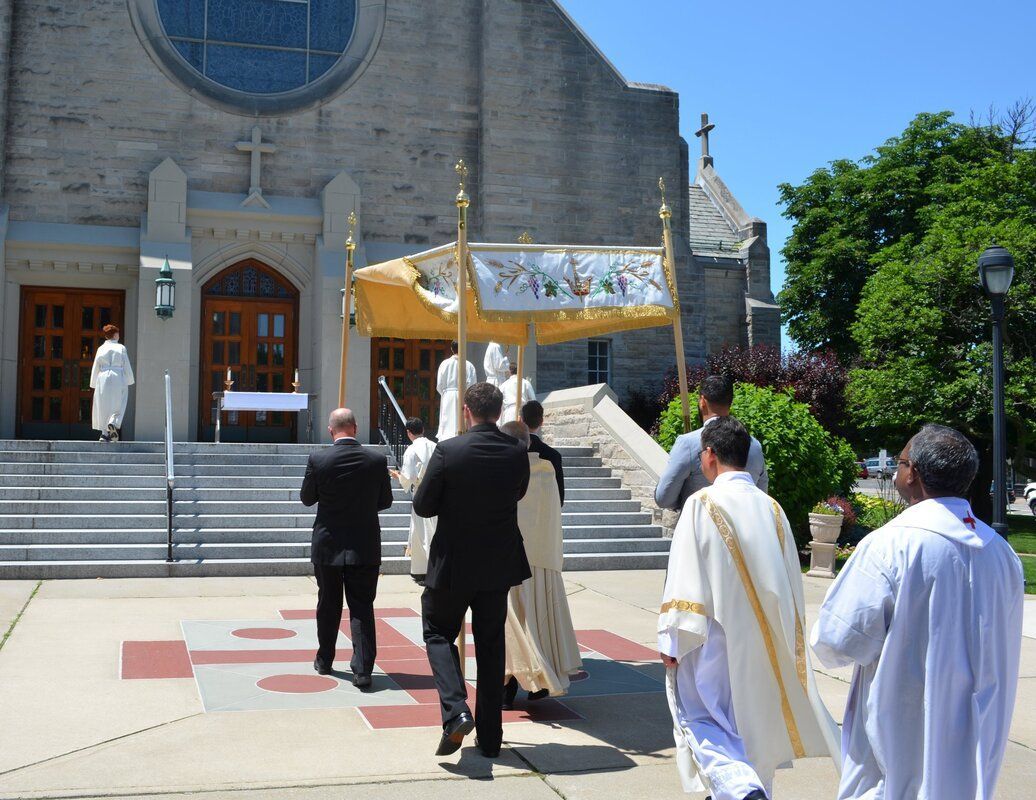 A group of priests are walking in front of a church