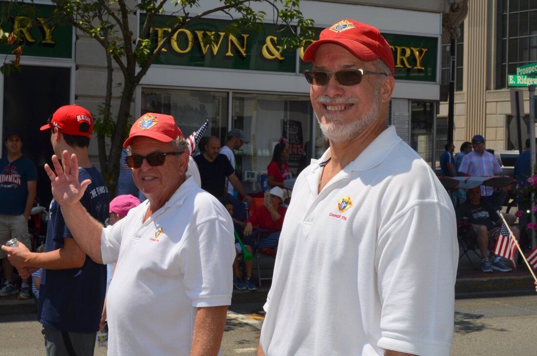 Two men are standing in front of a store called town & country