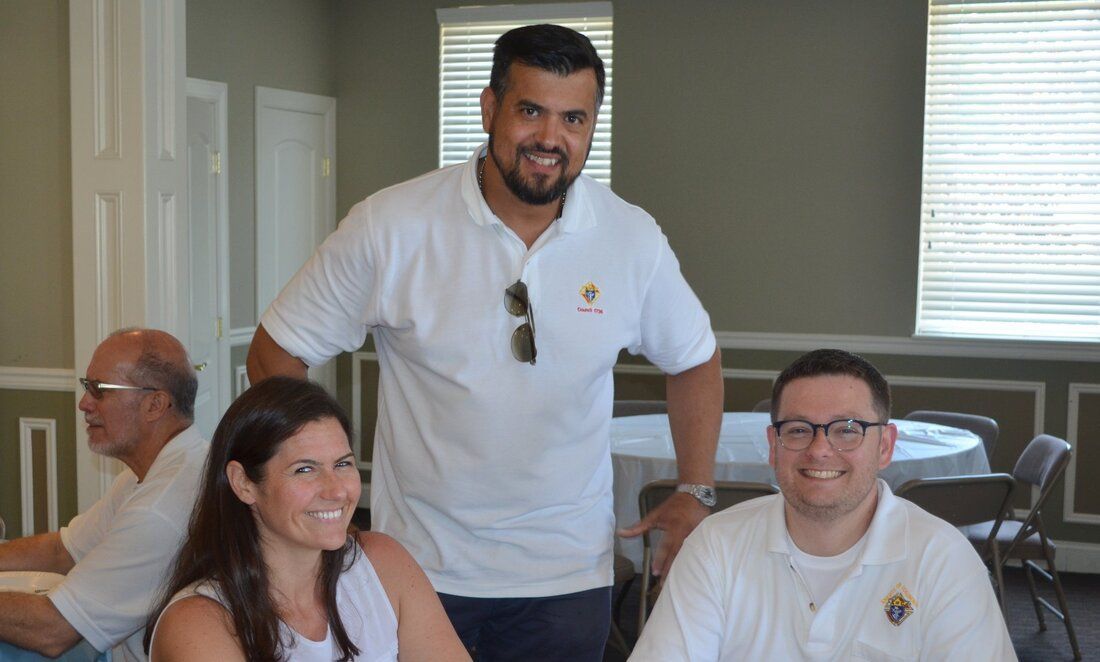 A group of people are posing for a picture in a room.