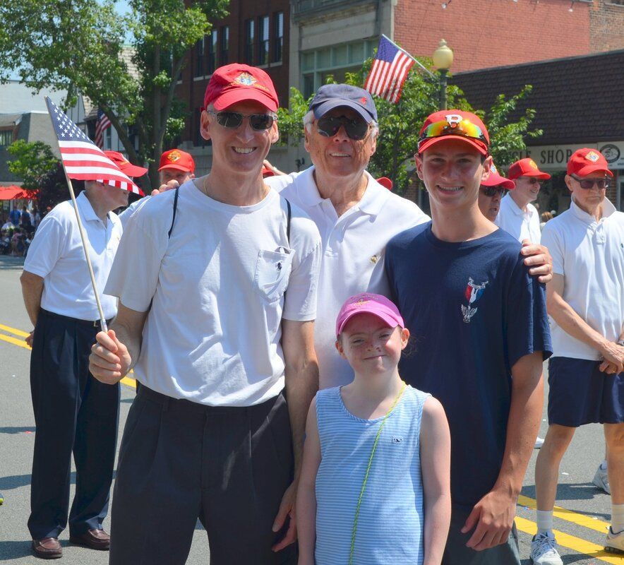 A group of people posing for a picture in front of a sign that says rio