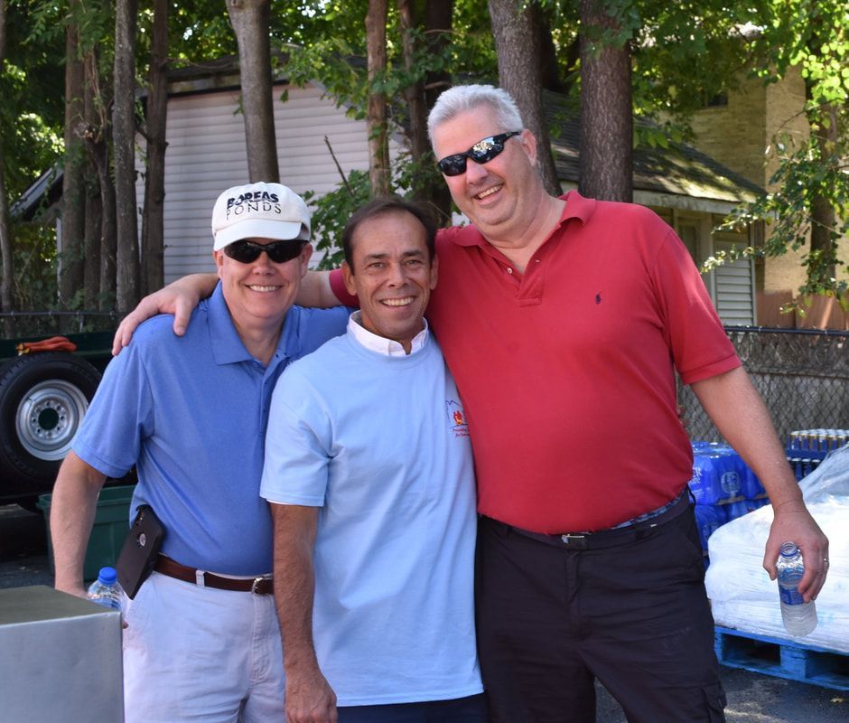 Three men are posing for a picture with one wearing a hat that says florida